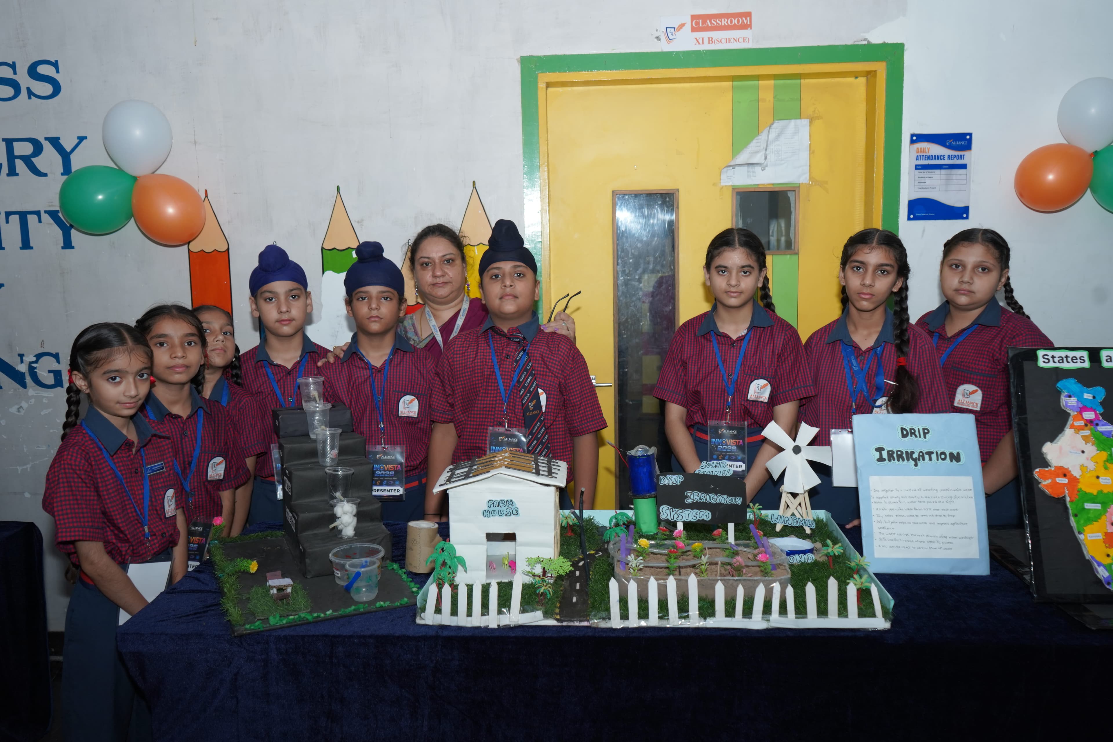 AIS students showcasing a drip irrigation model
