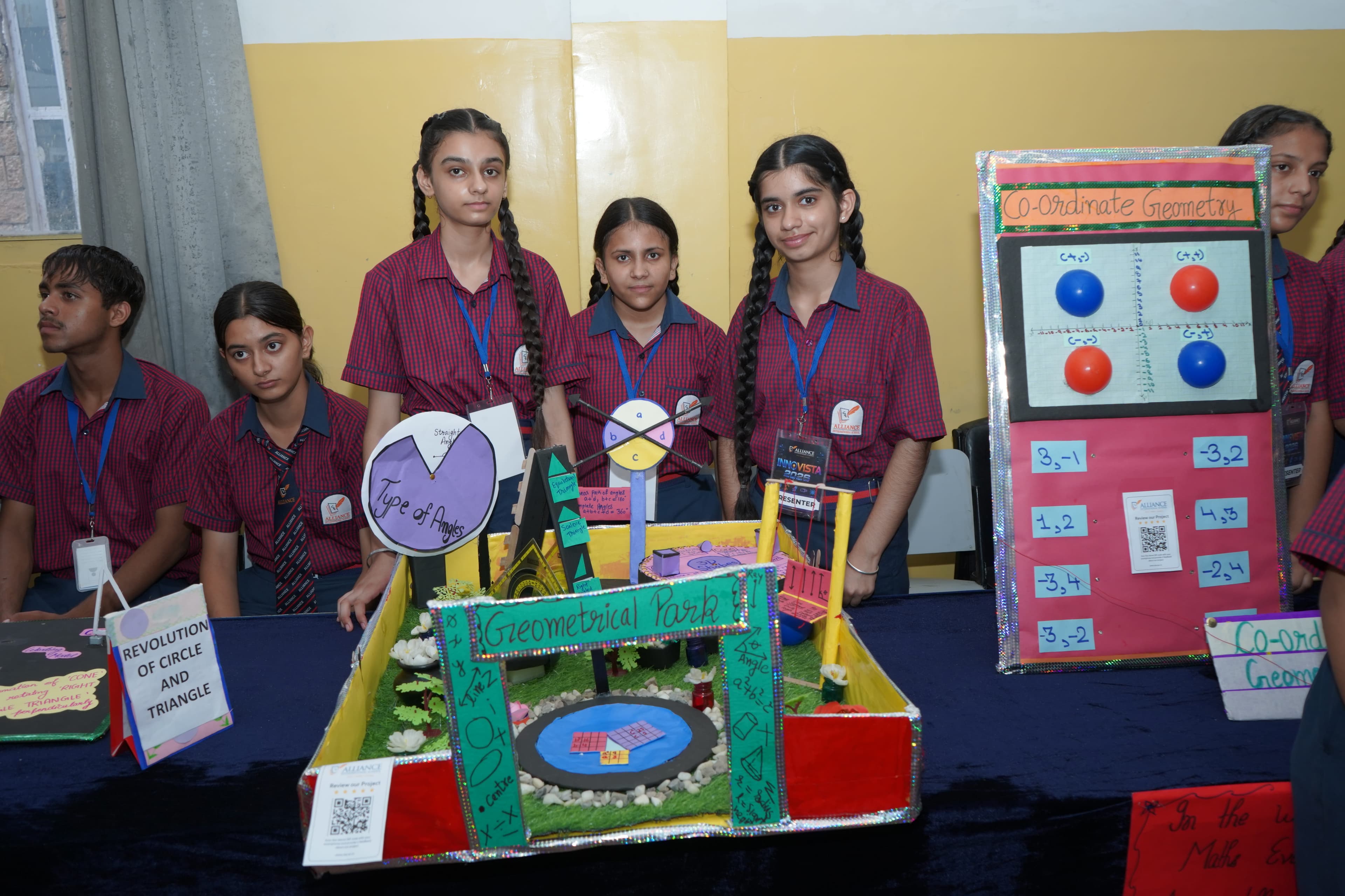 AIS students presenting a geometry-themed project model