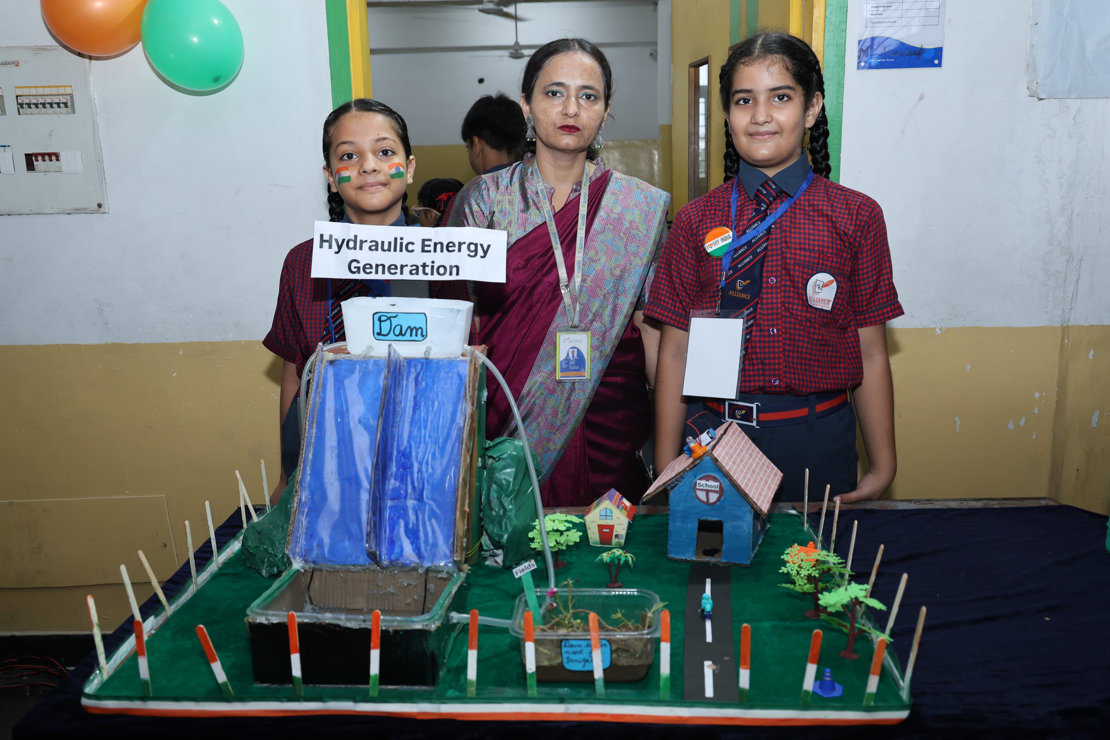 AIS students showcasing a hydraulic energy generation model