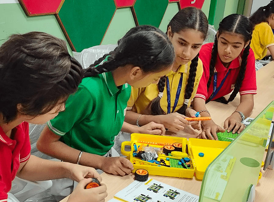 AIS students working on robots in the Robotics Lab